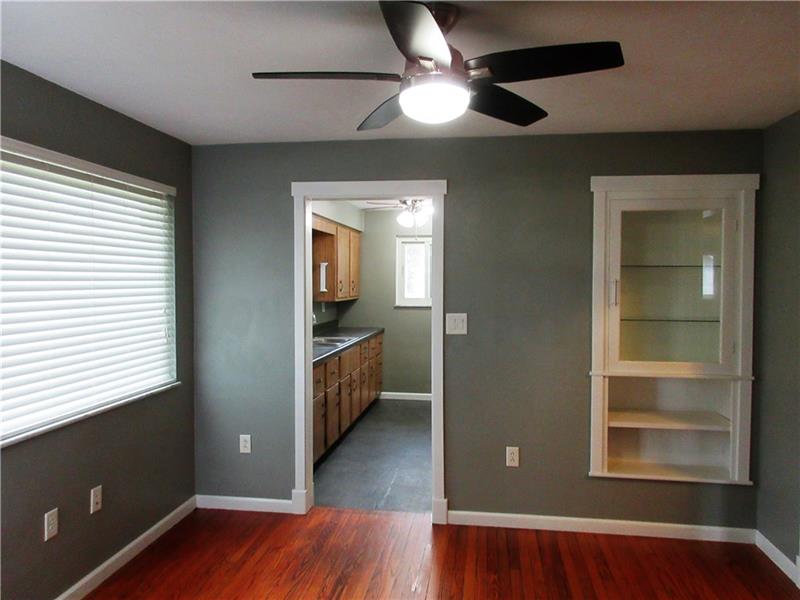 This dining area has a built in cabinet with shelves and a glass door, great for display or storage!