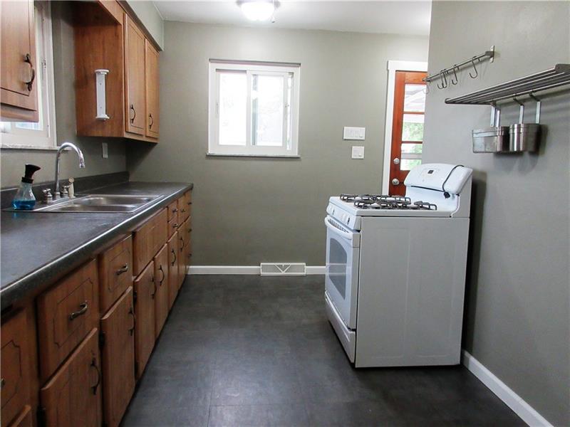 724 North Pike Road Cabot, PA 16023 - Photo 8 of 25 Additional view of kitchen and new vinyl floor. The gas stove is included in the sale of the home.