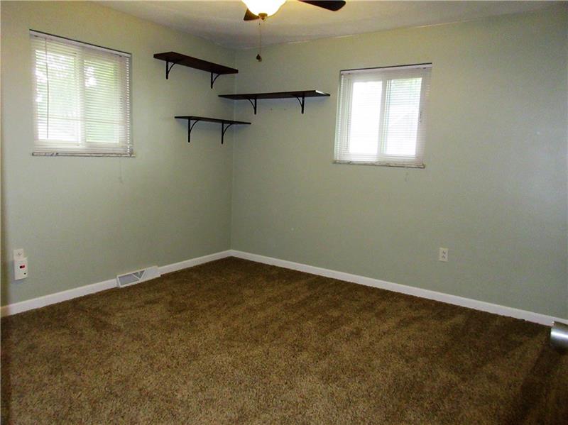 724 North Pike Road Cabot, PA 16023 - Photo 10 of 25 The master bedroom features a new lighted ceiling fan and plaster walls.