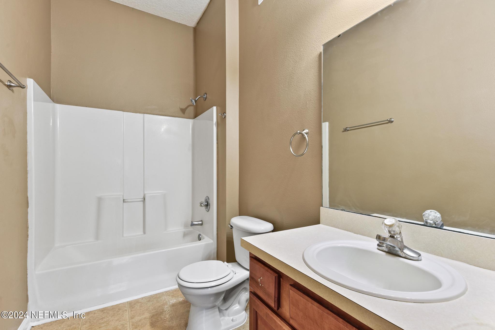 7920 Merrill Road, Unit 2205 Jacksonville, FL 32277 - Photo 11 of 21 a bathroom with a sink toilet and shower