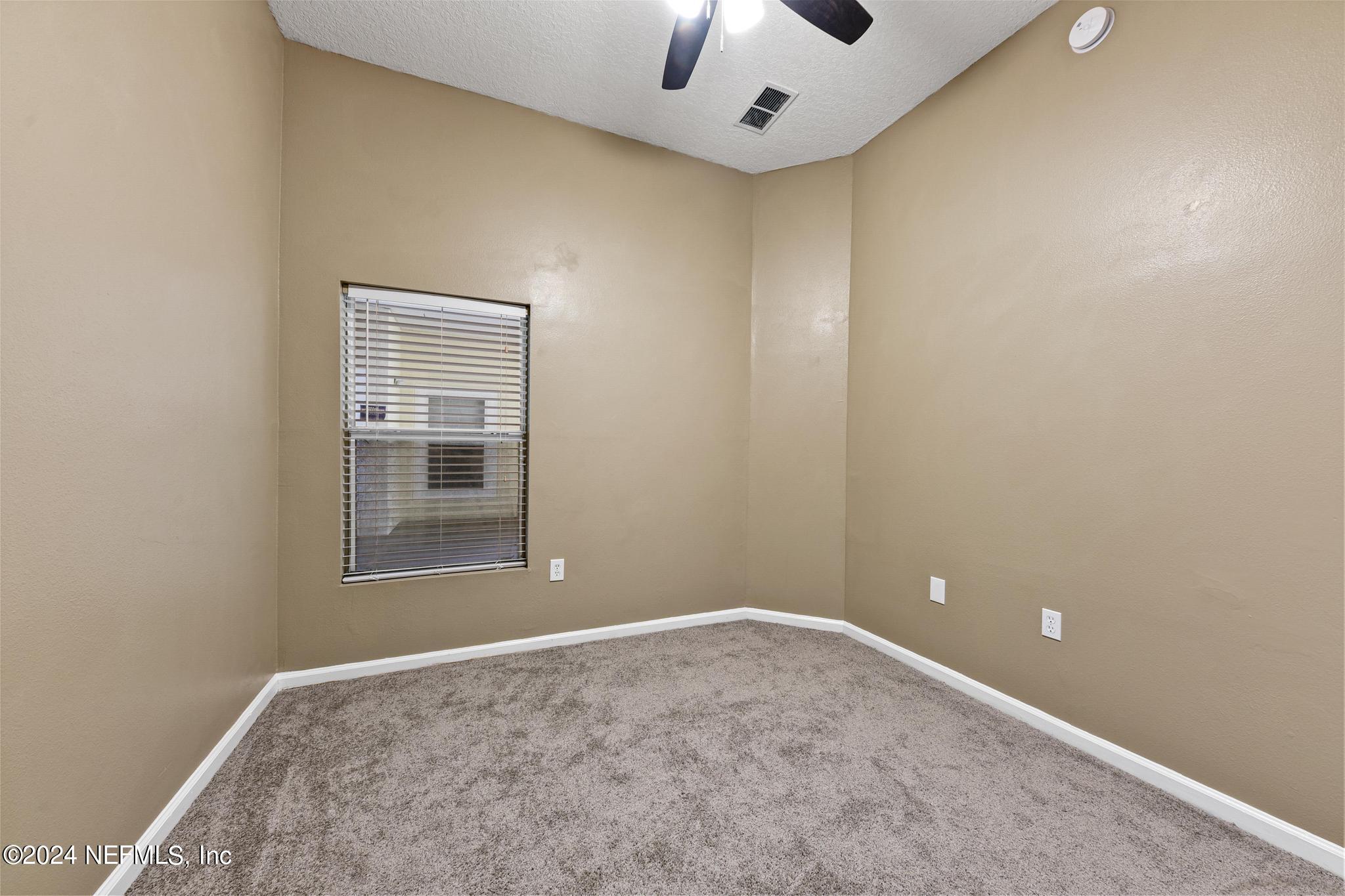 7920 Merrill Road, Unit 2205 Jacksonville, FL 32277 - Photo 13 of 21 an empty room with windows and closet