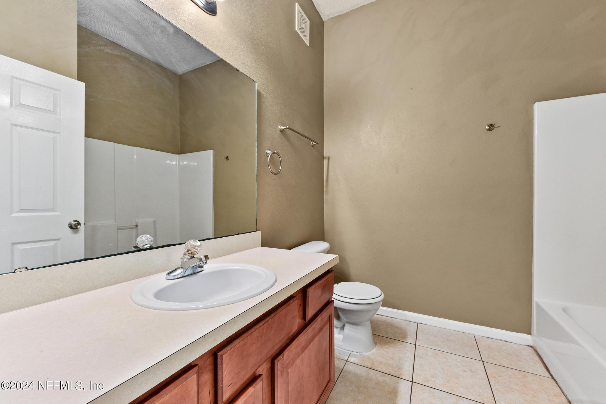 7920 Merrill Road, Unit 2205 Jacksonville, FL 32277 - Photo 15 of 21 a bathroom with a sink and a toilet