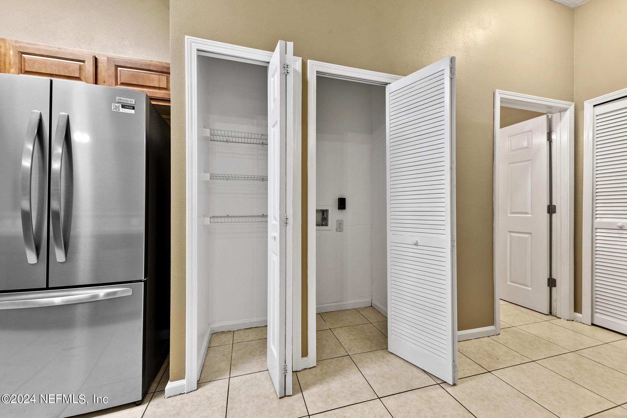 7920 Merrill Road, Unit 2205 Jacksonville, FL 32277 - Photo 17 of 21 a view of a refrigerator in kitchen and an empty room