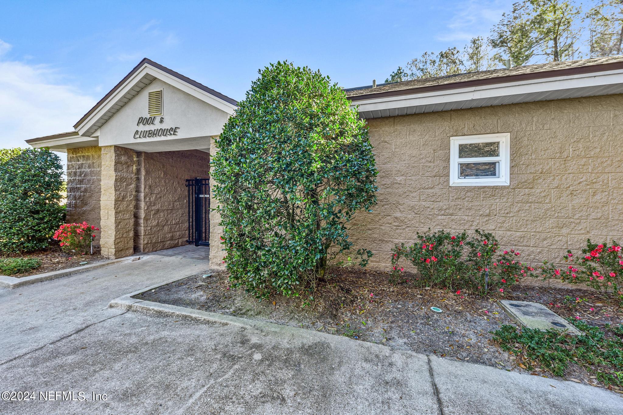 7920 Merrill Road, Unit 2205 Jacksonville, FL 32277 - Photo 18 of 21 a front view of a house with a yard