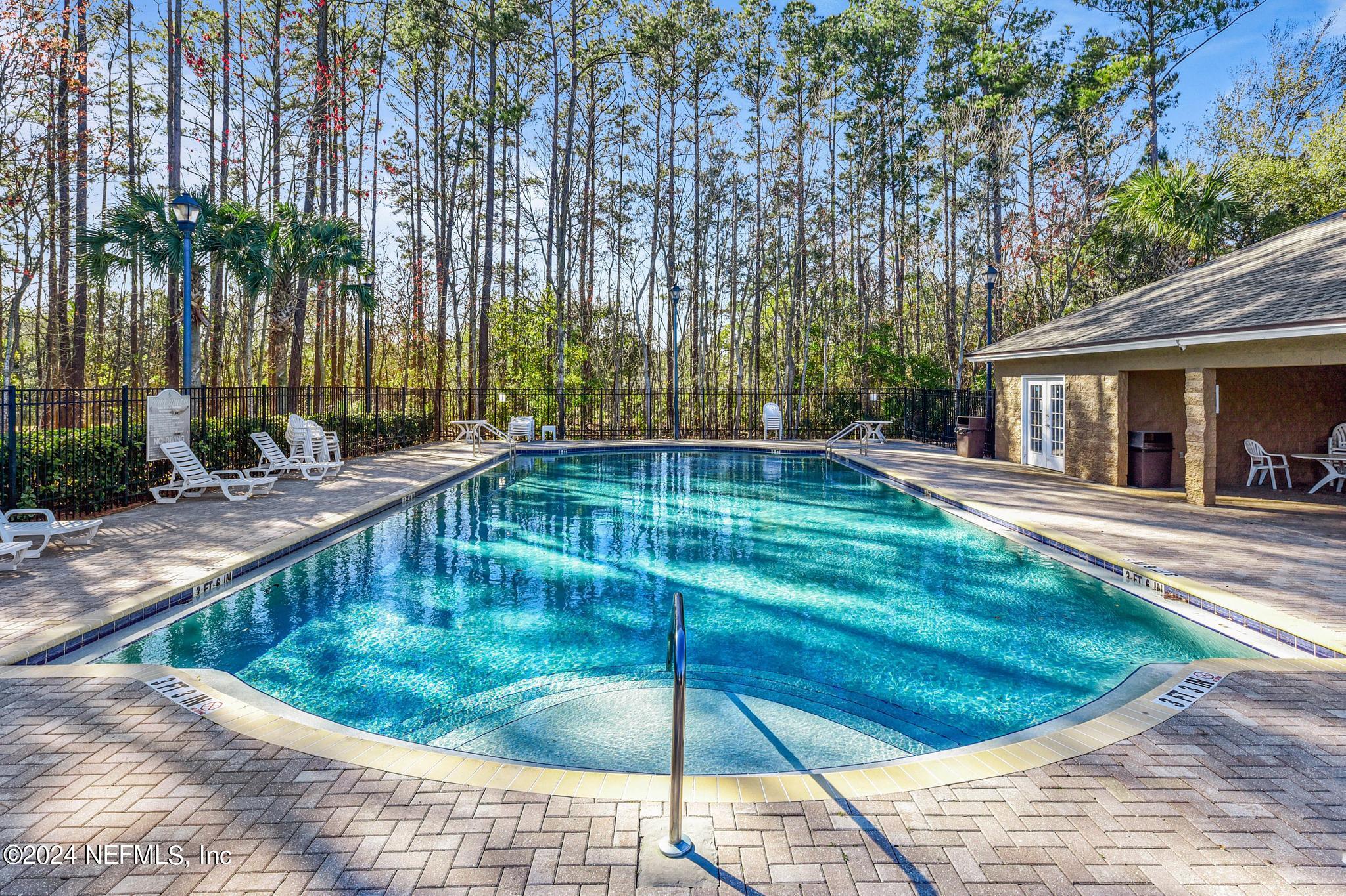 7920 Merrill Road, Unit 2205 Jacksonville, FL 32277 - Photo 20 of 21 a swimming pool with outdoor seating and yard