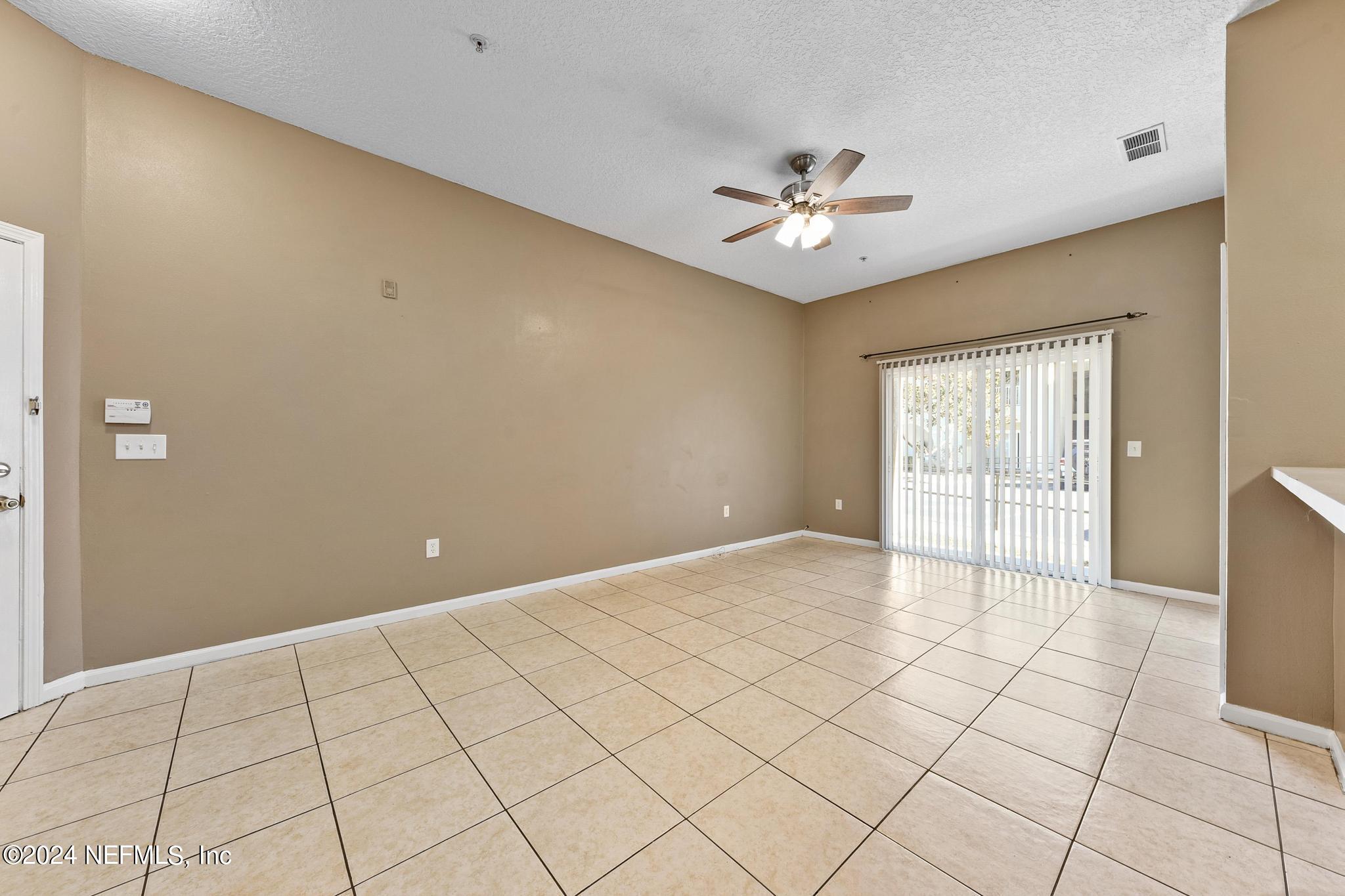 7920 Merrill Road, Unit 2205 Jacksonville, FL 32277 - Photo 3 of 21 a view of an empty room and window