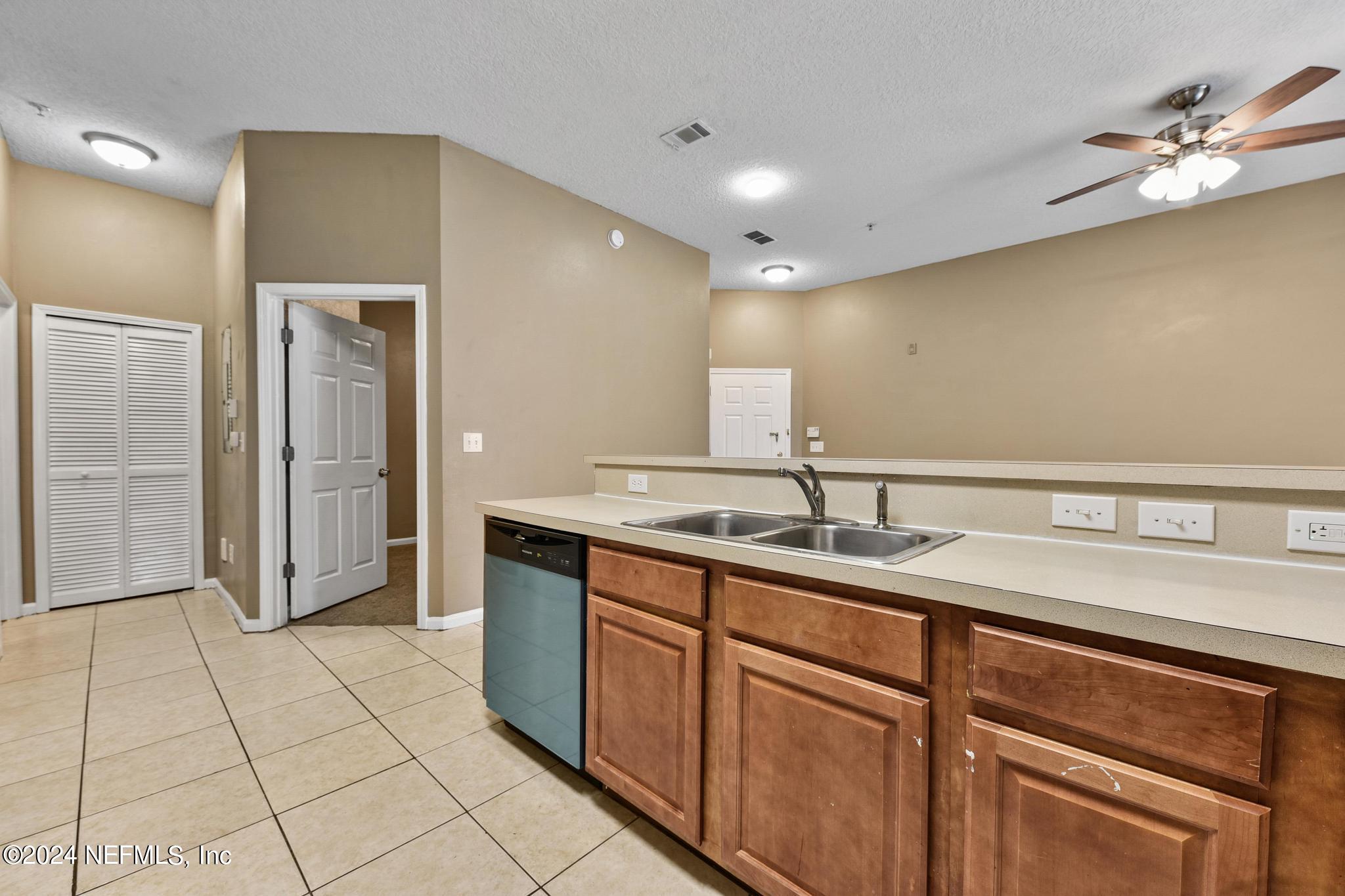 7920 Merrill Road, Unit 2205 Jacksonville, FL 32277 - Photo 7 of 21 a bathroom with a sink a mirror and a shower