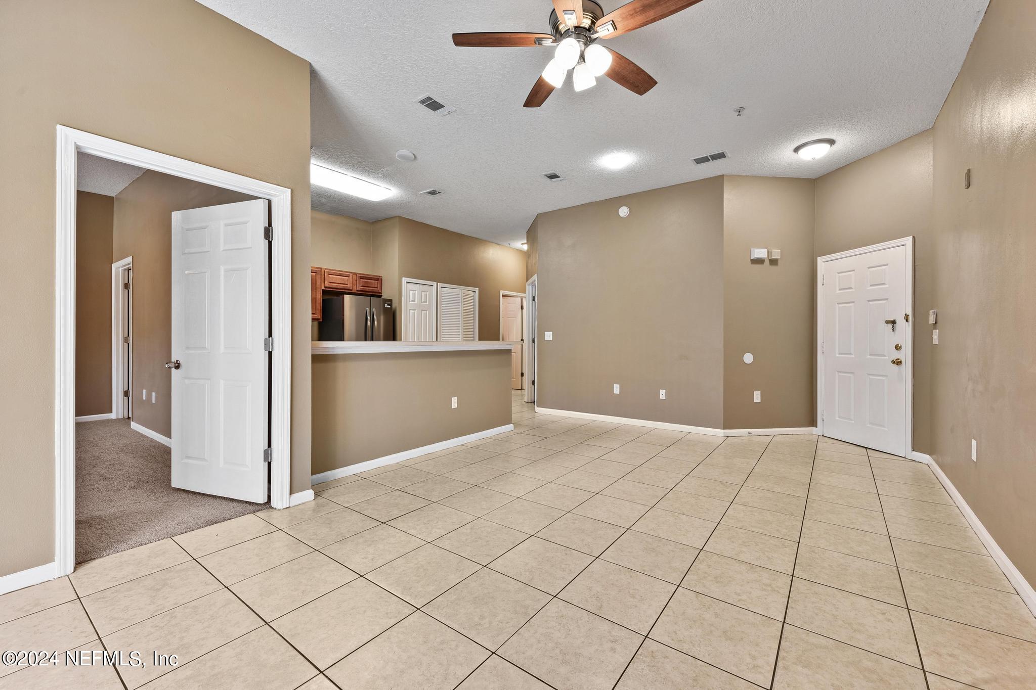 7920 Merrill Road, Unit 2205 Jacksonville, FL 32277 - Photo 8 of 21 a view of a livingroom with kitchen
