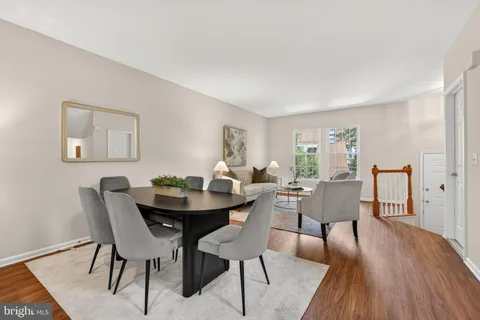a dining room with furniture and wooden floor
