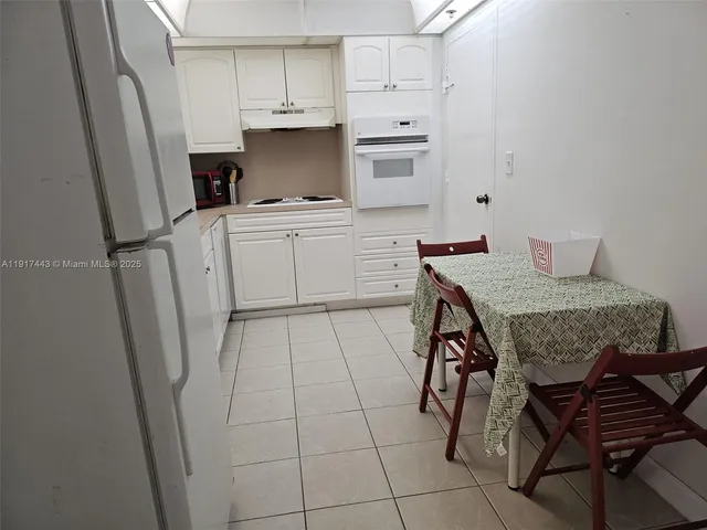 a kitchen with stainless steel appliances a stove a refrigerator and cabinets