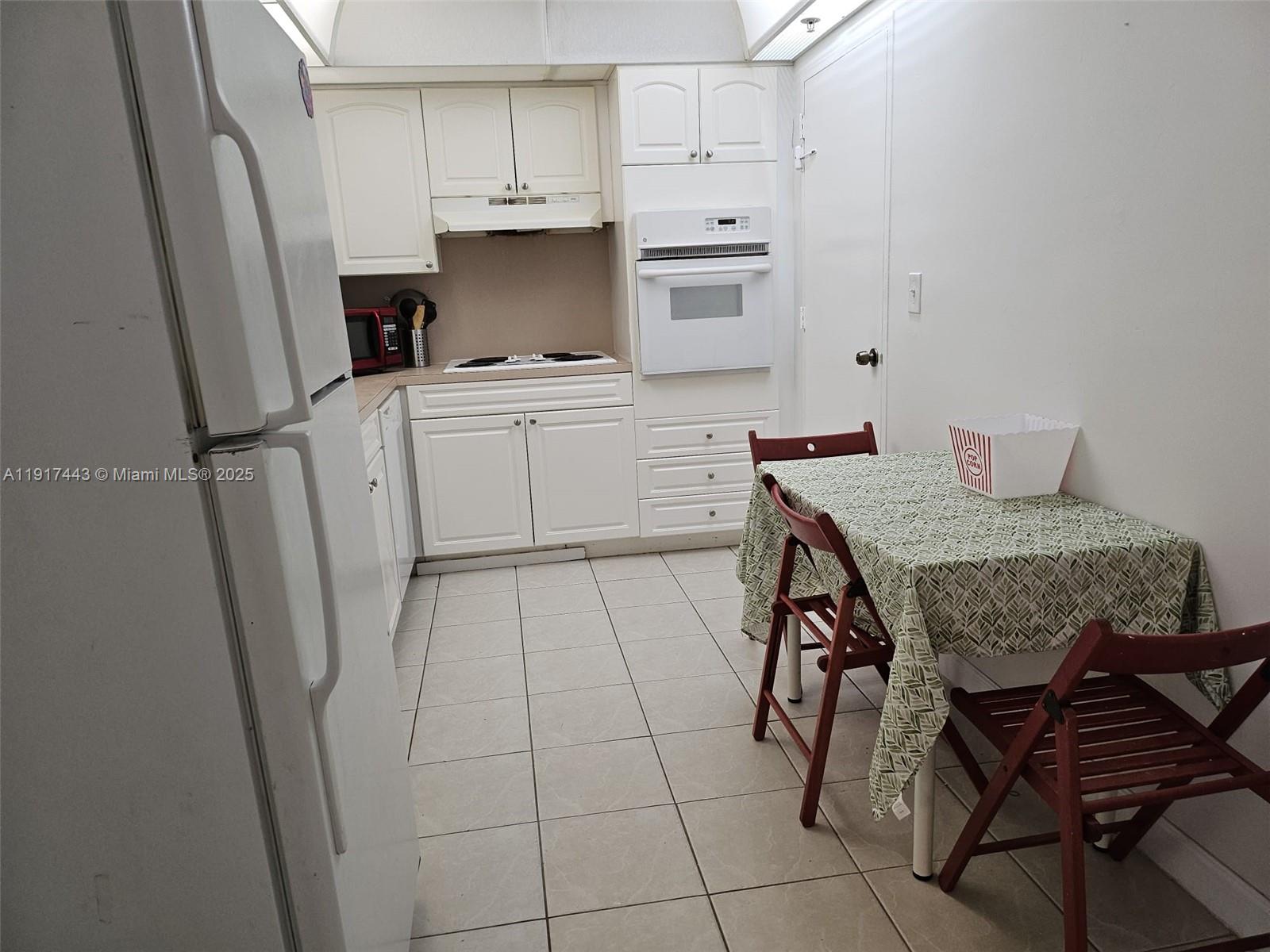 4001 South Ocean Drive, Unit 7F Hollywood, FL 33019 - Photo 3 of 20 a kitchen with stainless steel appliances a stove a refrigerator and cabinets