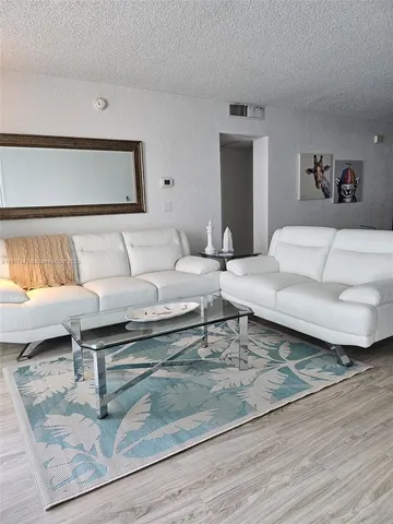 a living room with furniture and a rug
