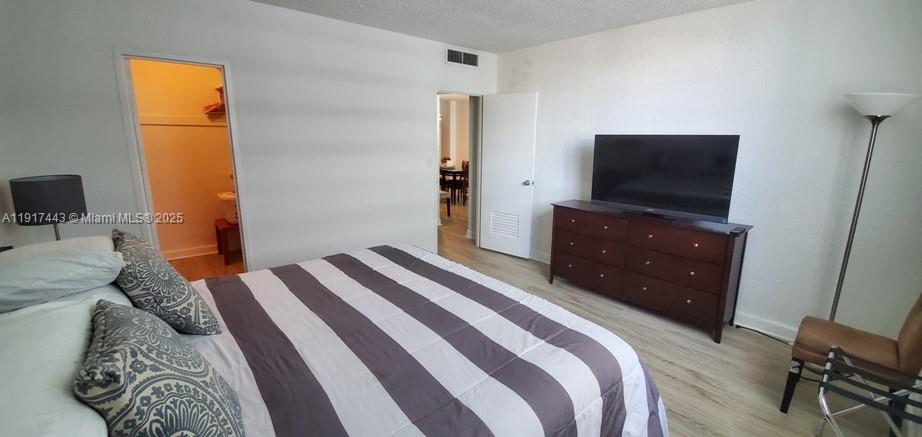4001 South Ocean Drive, Unit 7F Hollywood, FL 33019 - Photo 7 of 20 a bedroom with a bed and flat screen tv