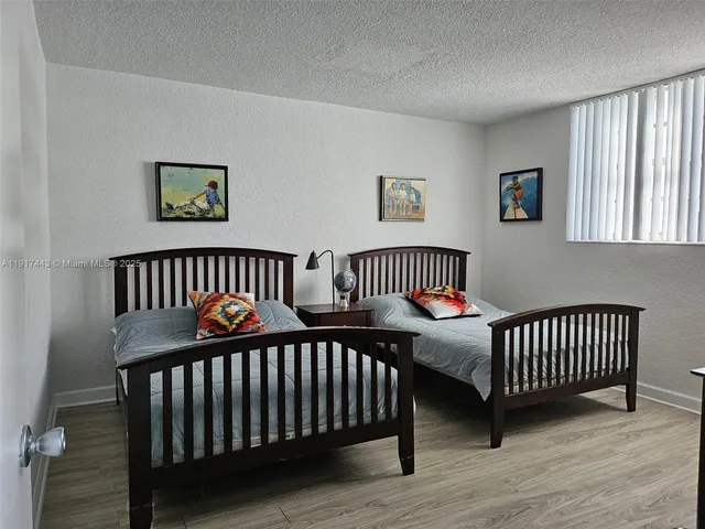 a bedroom with two beds and a window