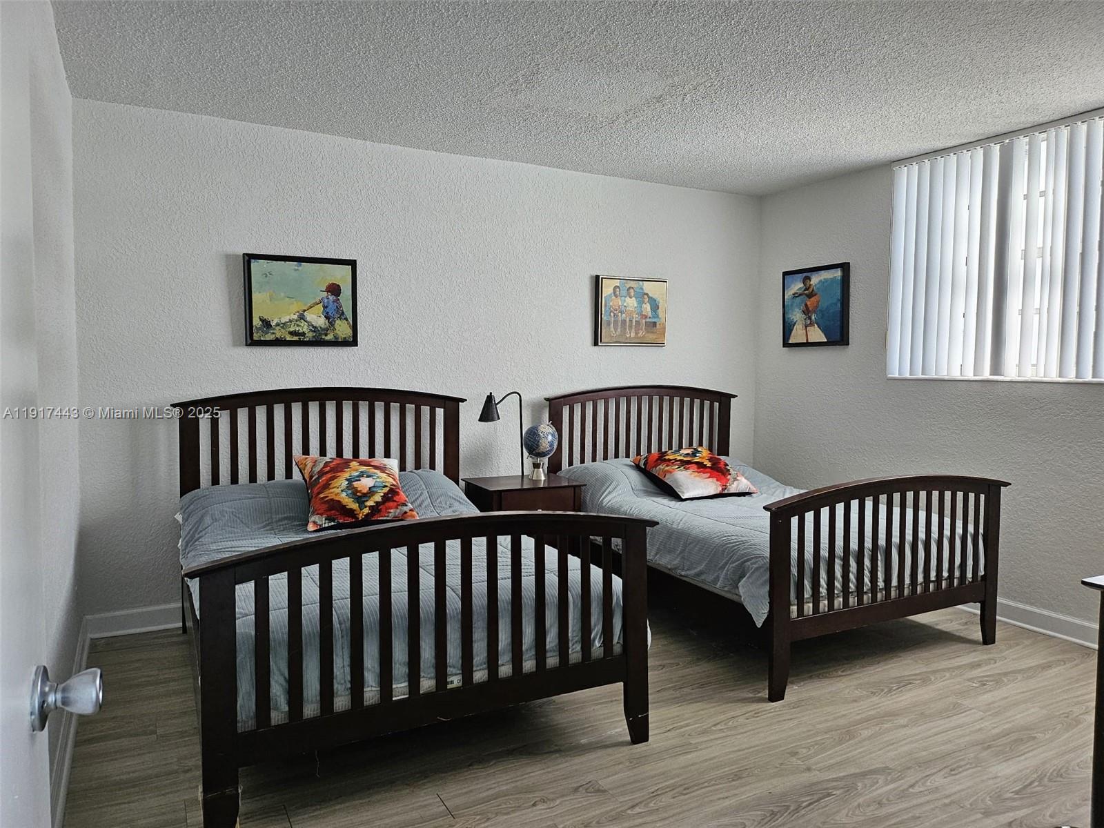 4001 South Ocean Drive, Unit 7F Hollywood, FL 33019 - Photo 9 of 20 a bedroom with two beds and a window