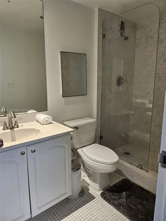 a bathroom with a sink toilet and shower