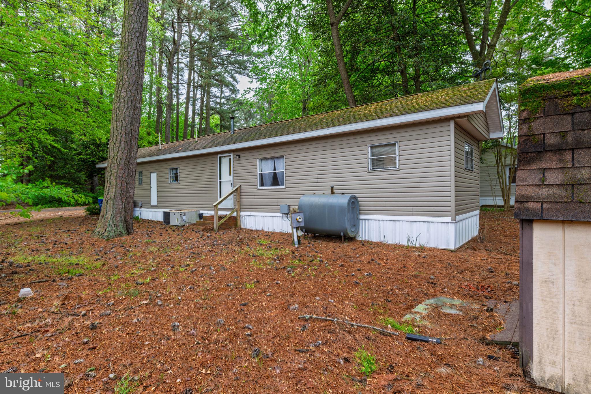 27284 Cottage Road, Unit 9182 Millsboro, DE 19966 - Photo 17 of 18 front view of a house with a patio