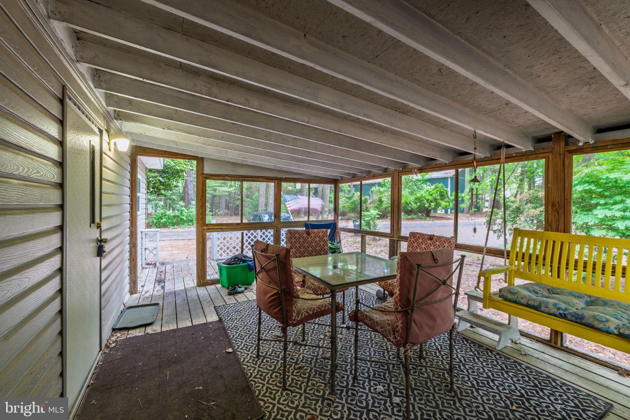 27284 Cottage Road, Unit 9182 Millsboro, DE 19966 - Photo 3 of 18 a dining room with furniture and a garden view