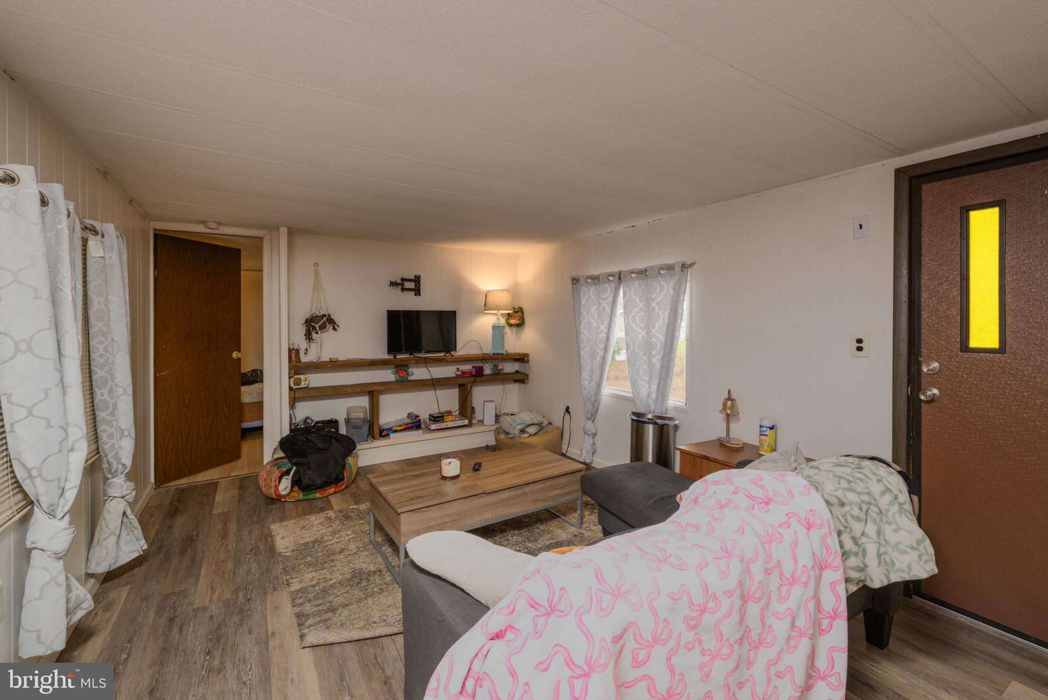 27284 Cottage Road, Unit 9182 Millsboro, DE 19966 - Photo 5 of 18 a bed room with two beds and a television