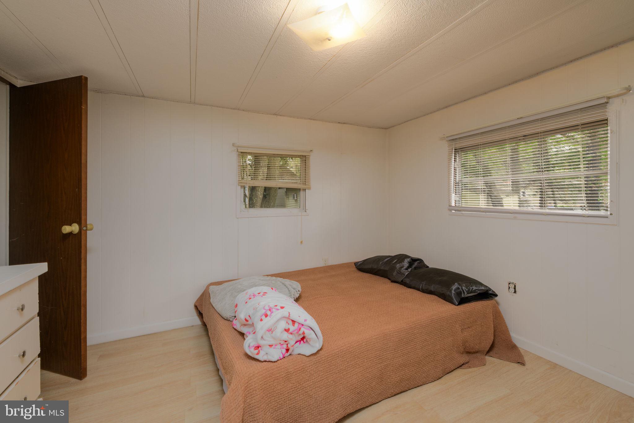 27284 Cottage Road, Unit 9182 Millsboro, DE 19966 - Photo 10 of 18 a bedroom with a bed and a window