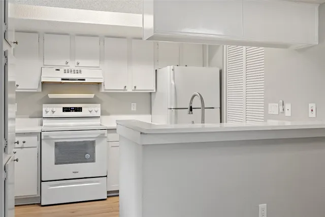 a kitchen with appliances cabinets and a sink