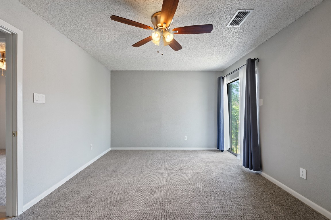 7635 Guadalupe Street, Unit 102 Austin, TX 78752 - Photo 22 of 36 an empty room with windows and fan