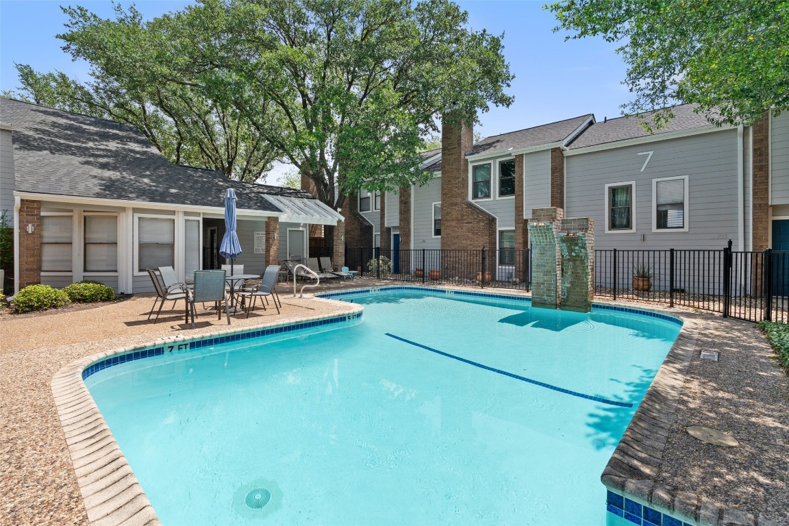 7635 Guadalupe Street, Unit 102 Austin, TX 78752 - Photo 31 of 36 a view of a house with swimming pool and porch with furniture