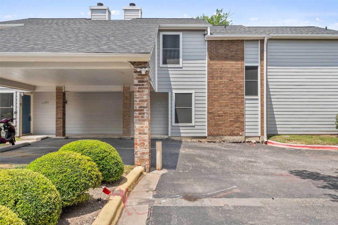 7635 Guadalupe Street, Unit 102 Austin, TX 78752 - Photo 34 of 36 a front view of a house with garden