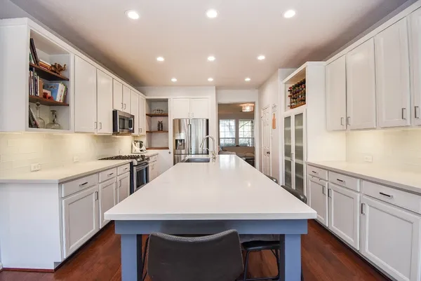 a kitchen with a stove a sink and a refrigerator