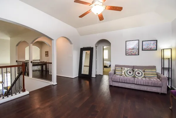 a living room with furniture and wooden floor