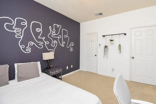 a bedroom with a bed and bathroom