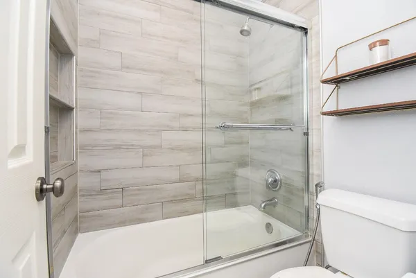 a bathroom with a bathtub and a shower