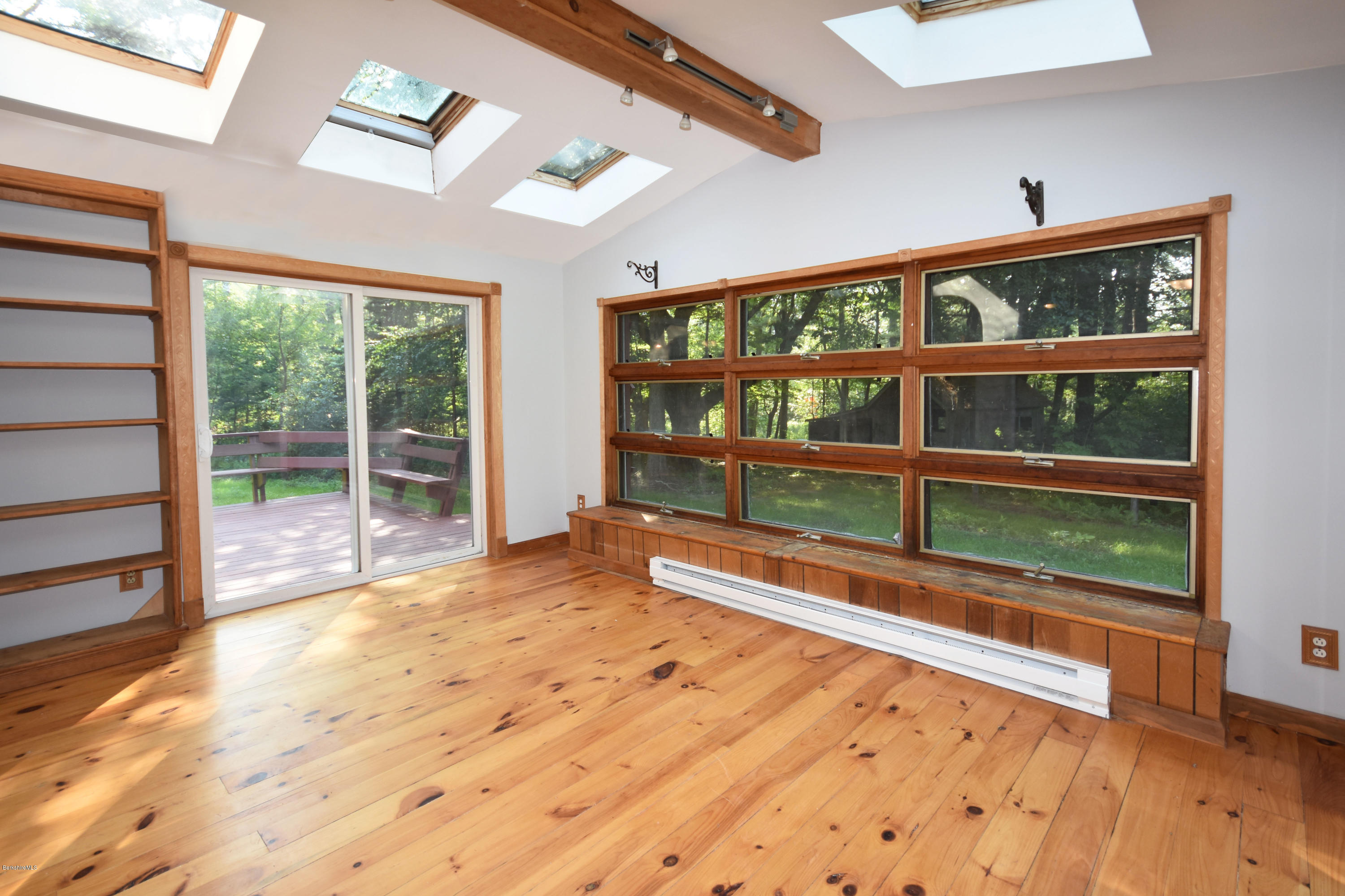 834 George Carter Road Becket, MA 01223 - Photo 13 of 61 a view of a room with wooden floor and windows