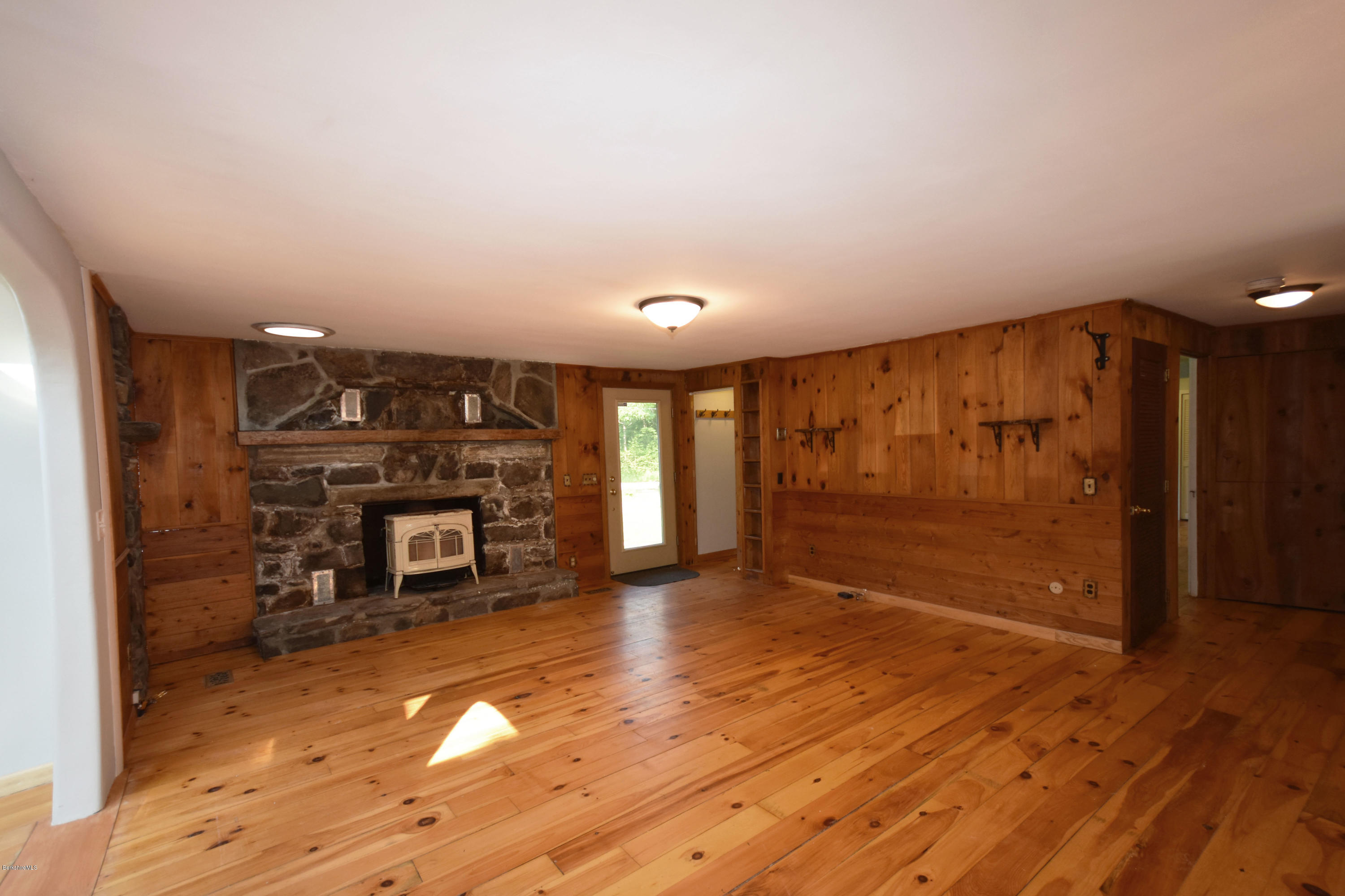 834 George Carter Road Becket, MA 01223 - Photo 17 of 61 a view of a room with wooden floor fire place and windows