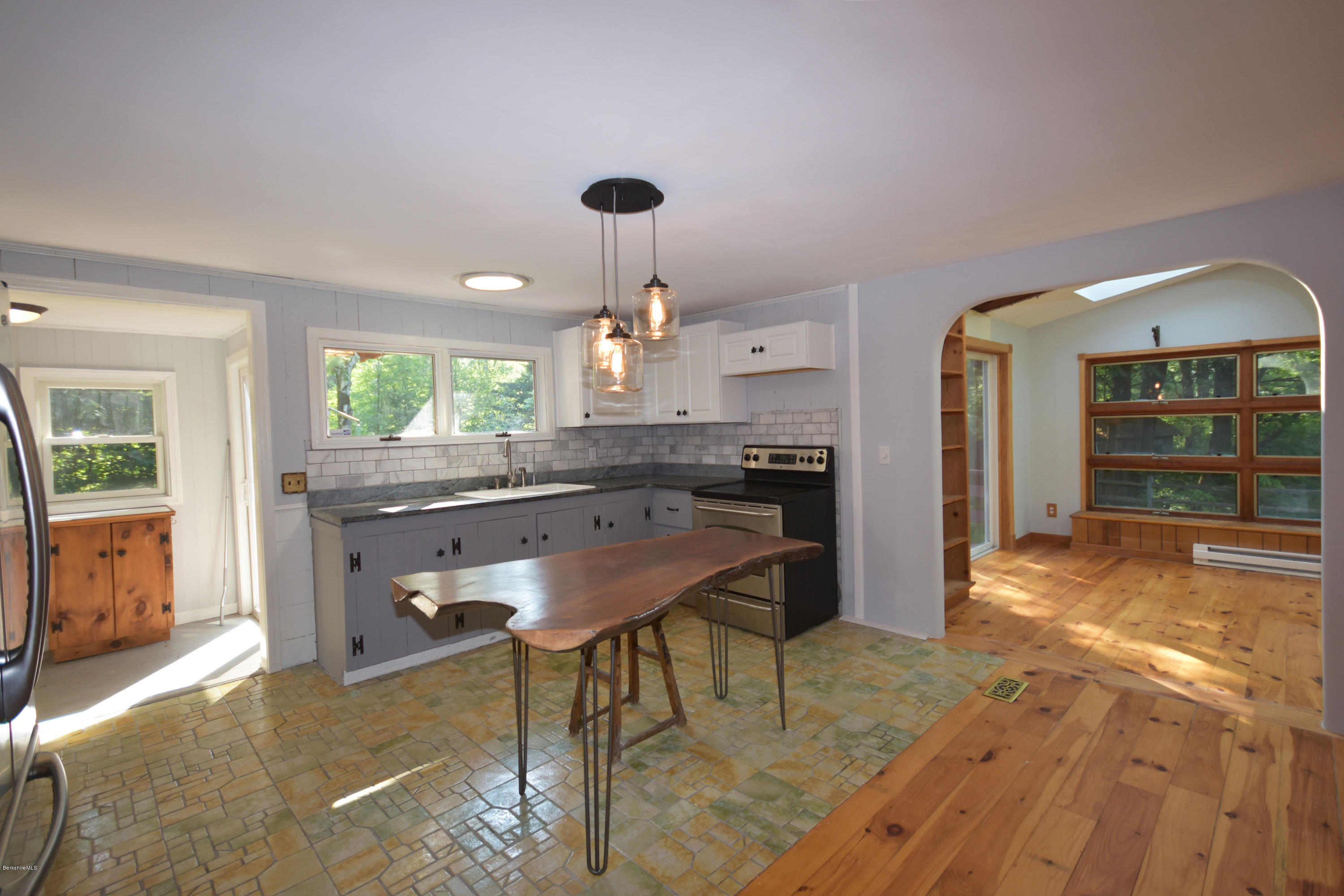 834 George Carter Road Becket, MA 01223 - Photo 20 of 61 a kitchen with a table and chairs in it