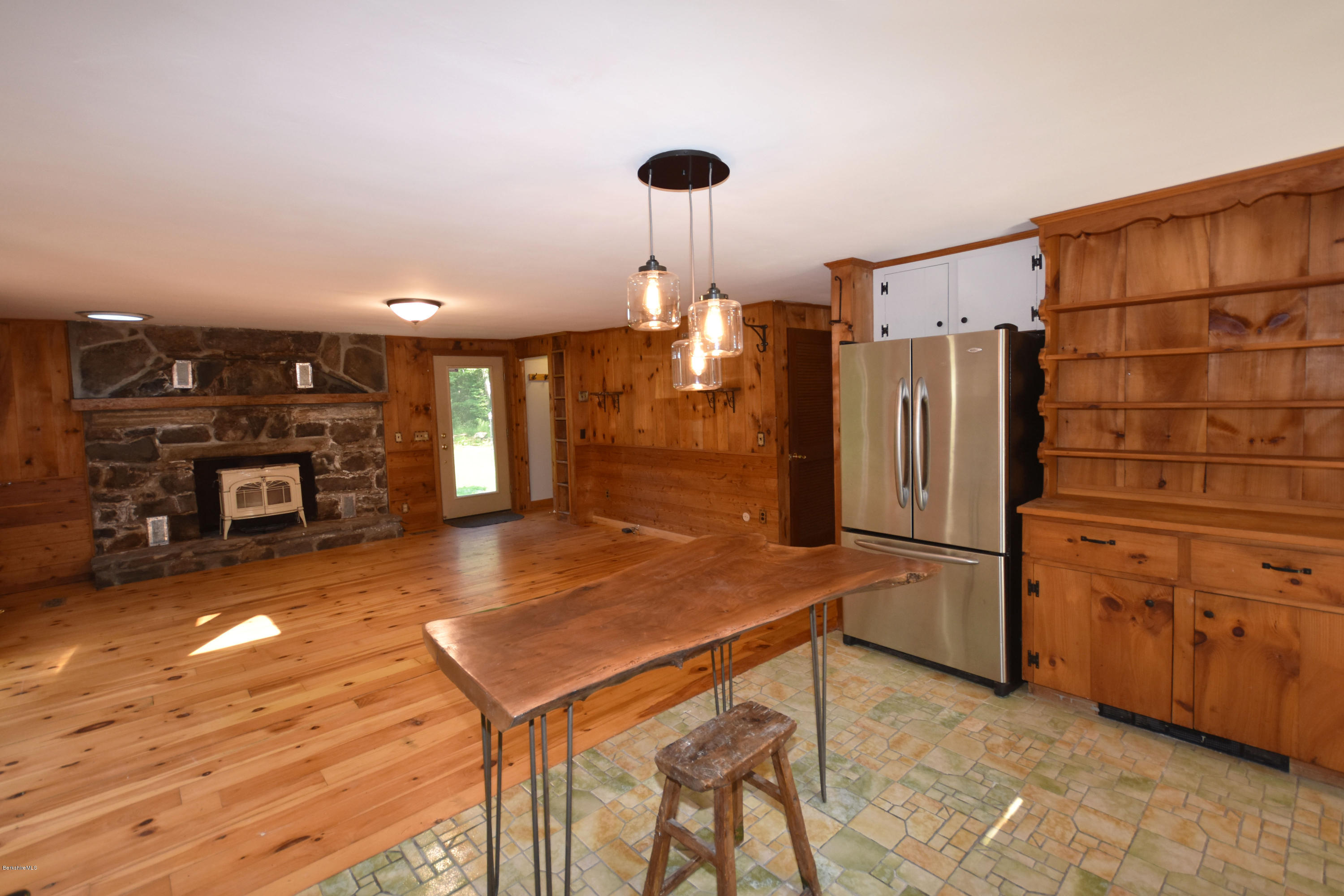 834 George Carter Road Becket, MA 01223 - Photo 23 of 61 a kitchen with stainless steel appliances kitchen island granite countertop a refrigerator a stove and a cabinets with wooden floor