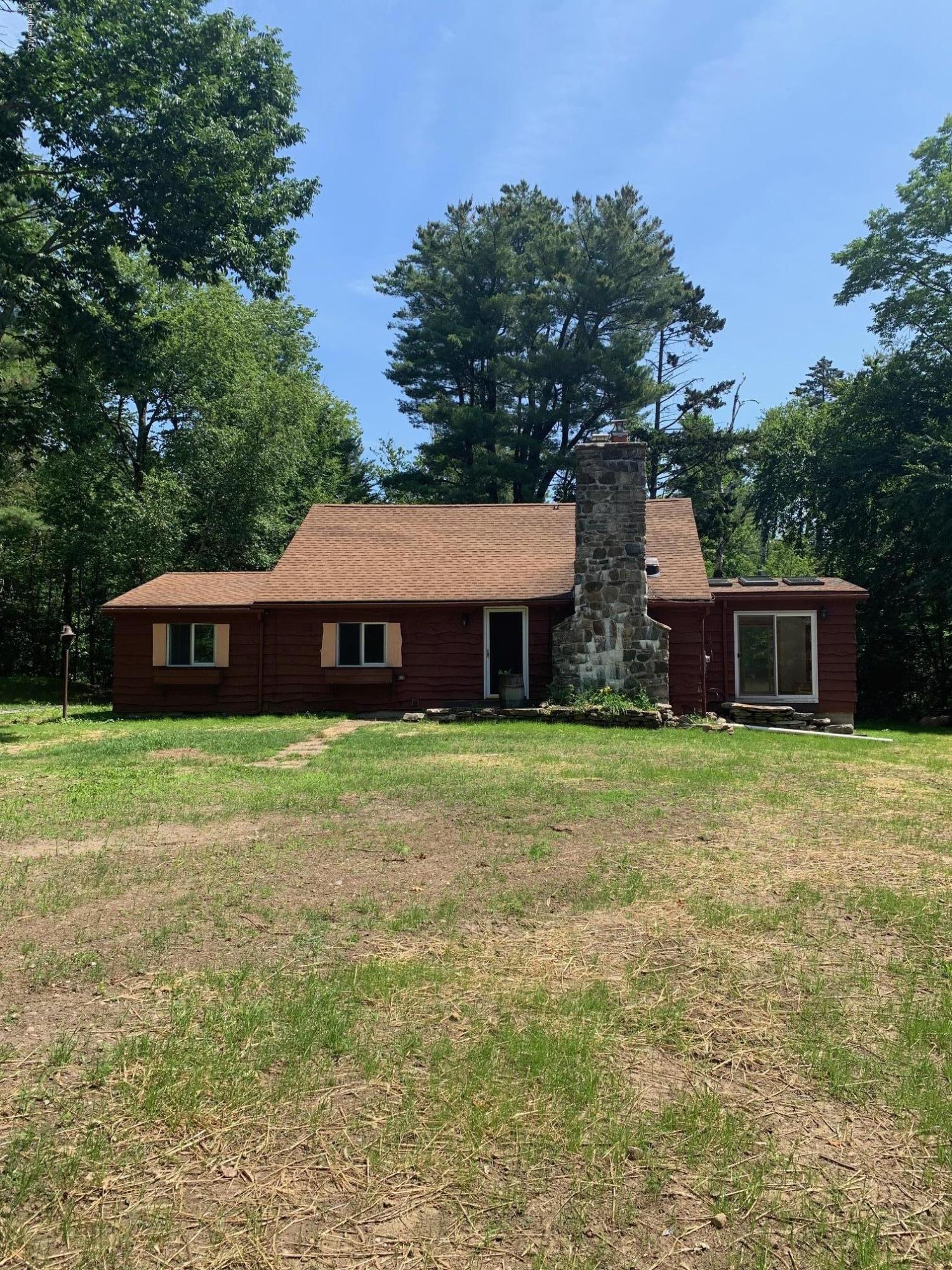 834 George Carter Road Becket, MA 01223 - Photo 3 of 61 a front view of a house with a garden