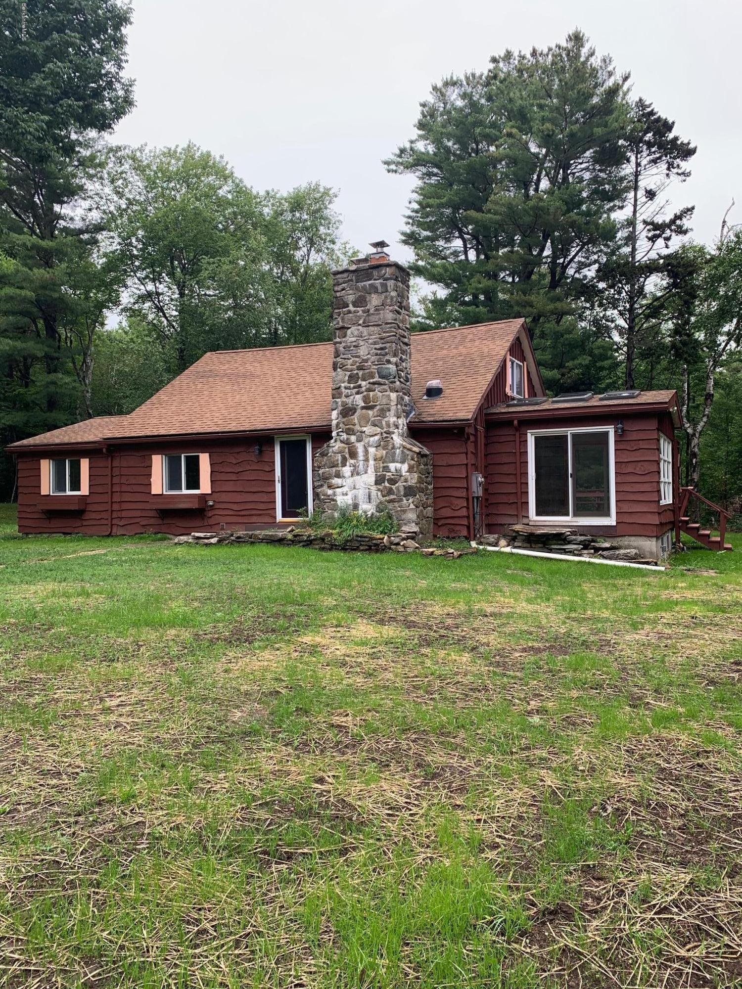834 George Carter Road Becket, MA 01223 - Photo 4 of 61 a front view of a house with a garden