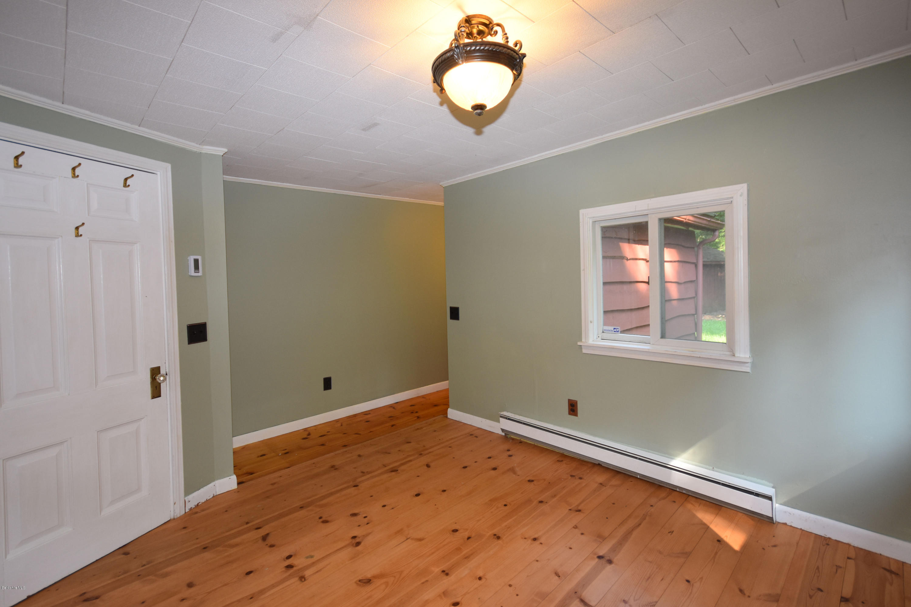 834 George Carter Road Becket, MA 01223 - Photo 31 of 61 a view of a room with wooden floor and windows