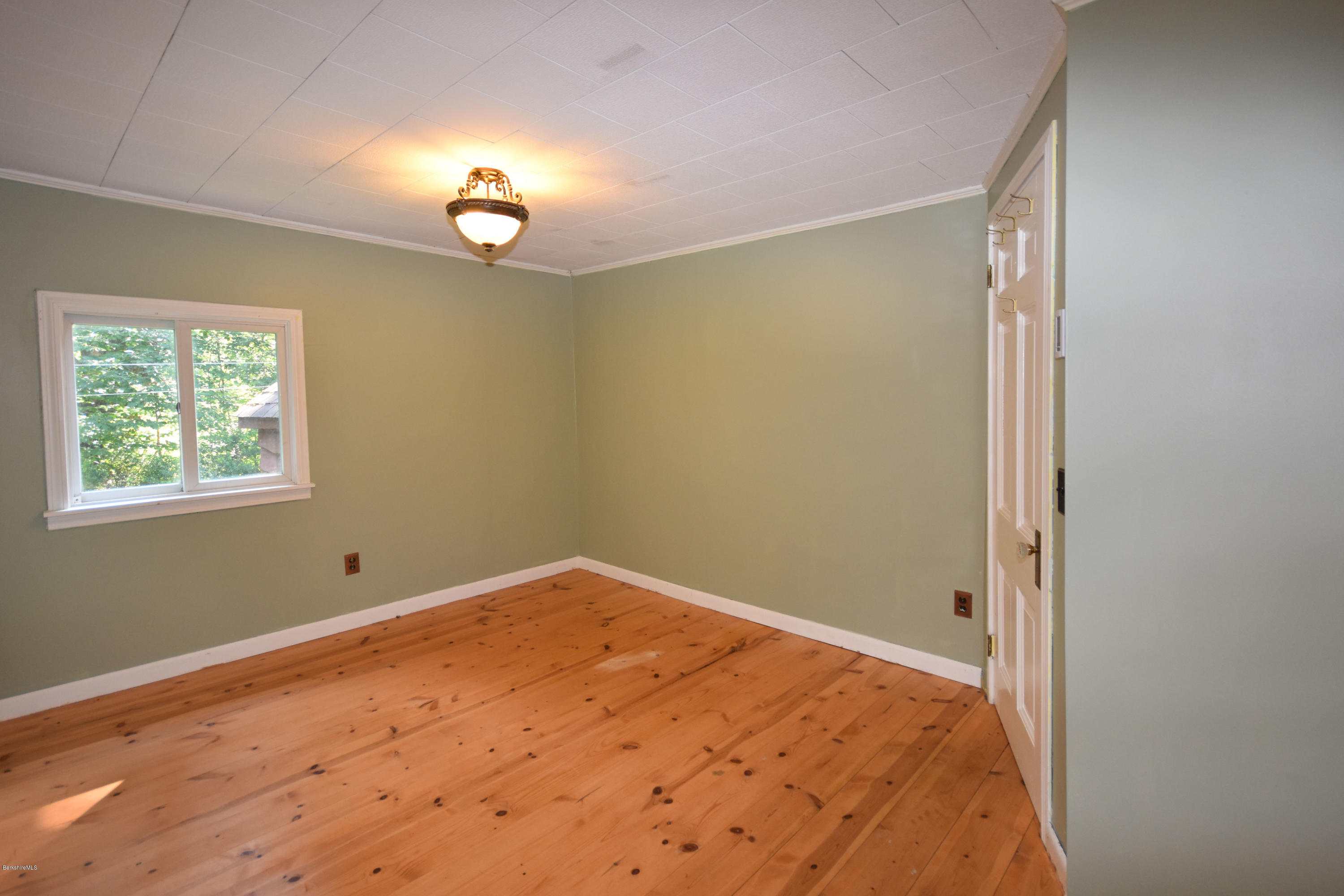 834 George Carter Road Becket, MA 01223 - Photo 32 of 61 a view of an empty room with a window
