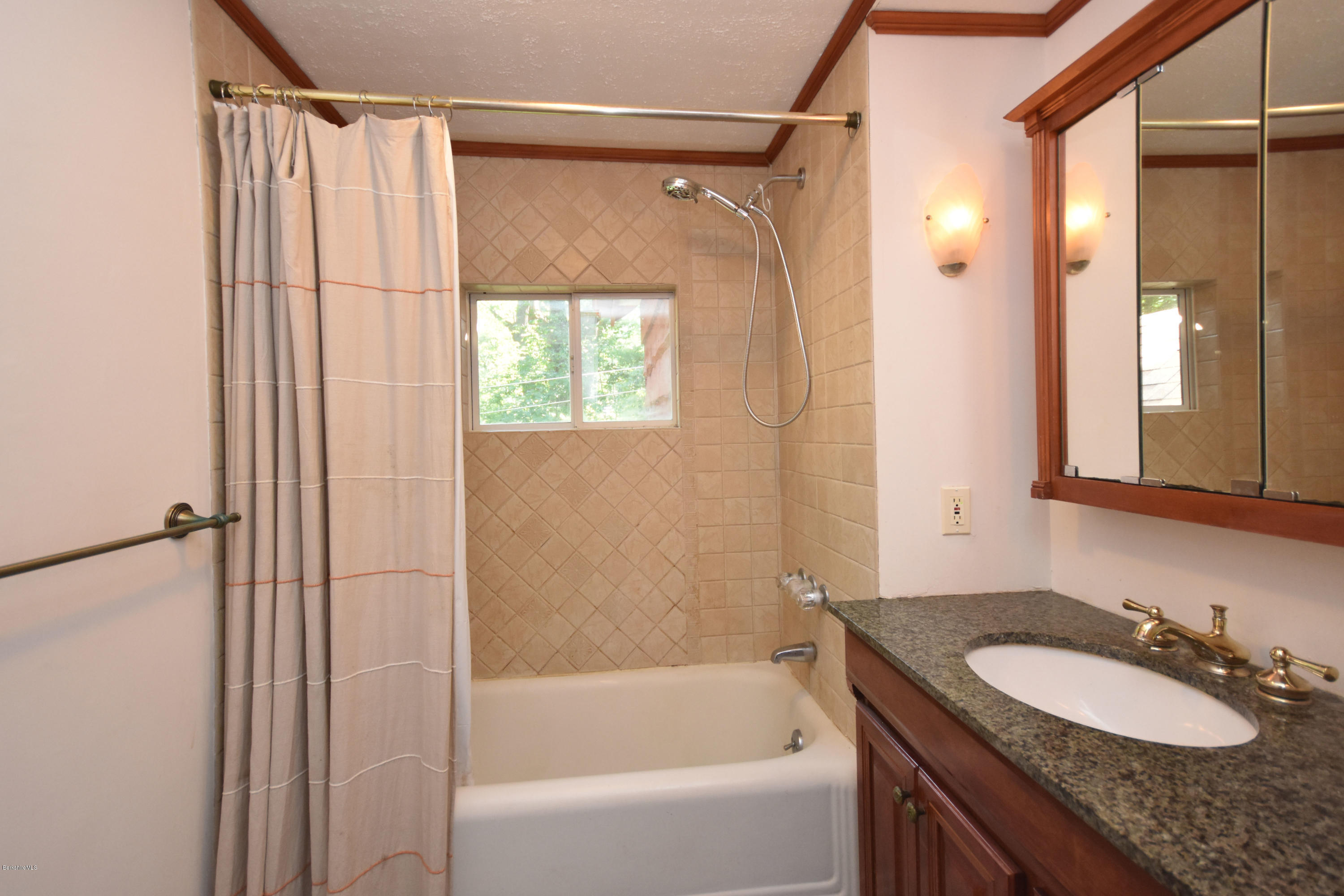834 George Carter Road Becket, MA 01223 - Photo 35 of 61 a bathroom with a granite countertop sink and a mirror