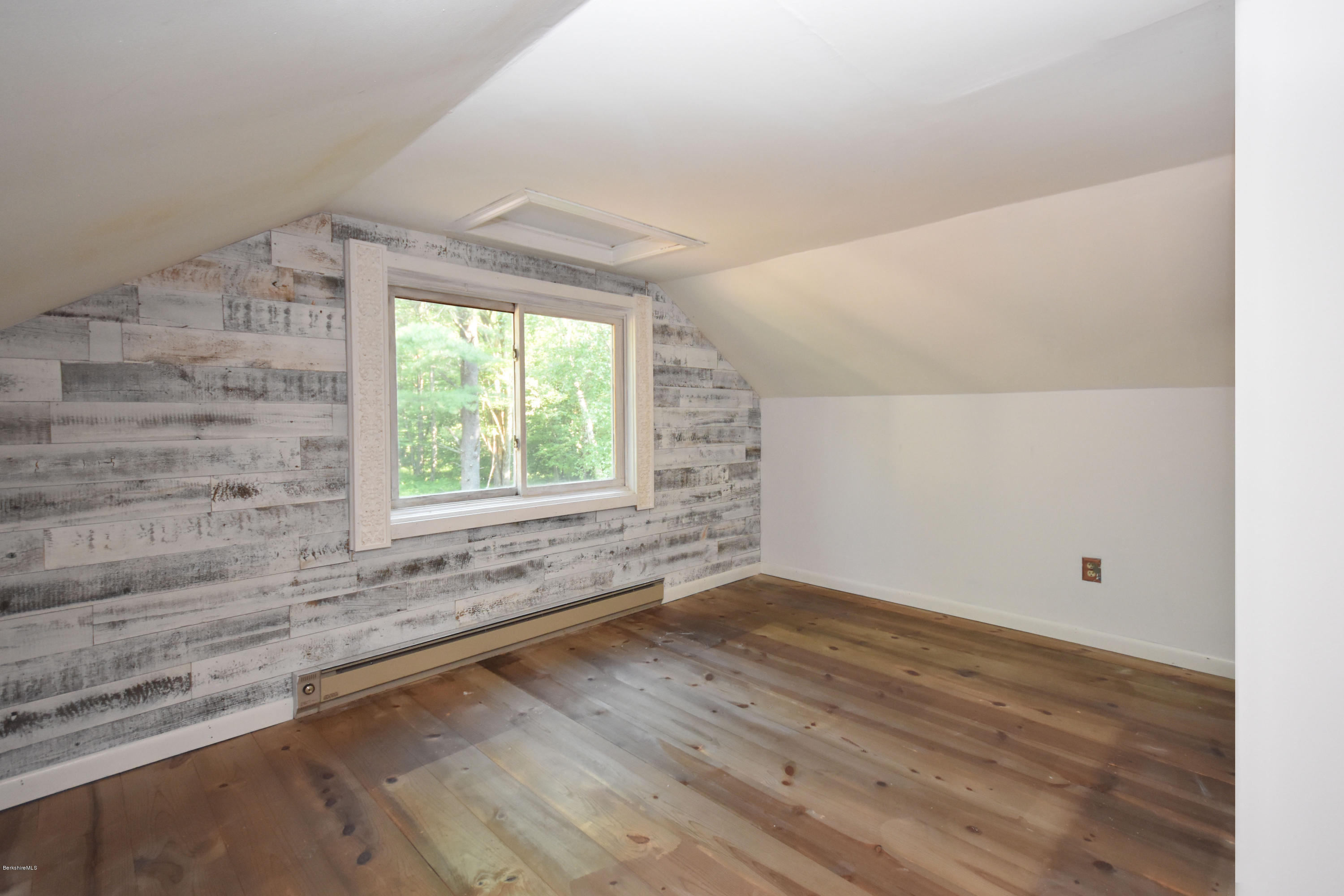834 George Carter Road Becket, MA 01223 - Photo 41 of 61 an empty room with wooden floor and windows