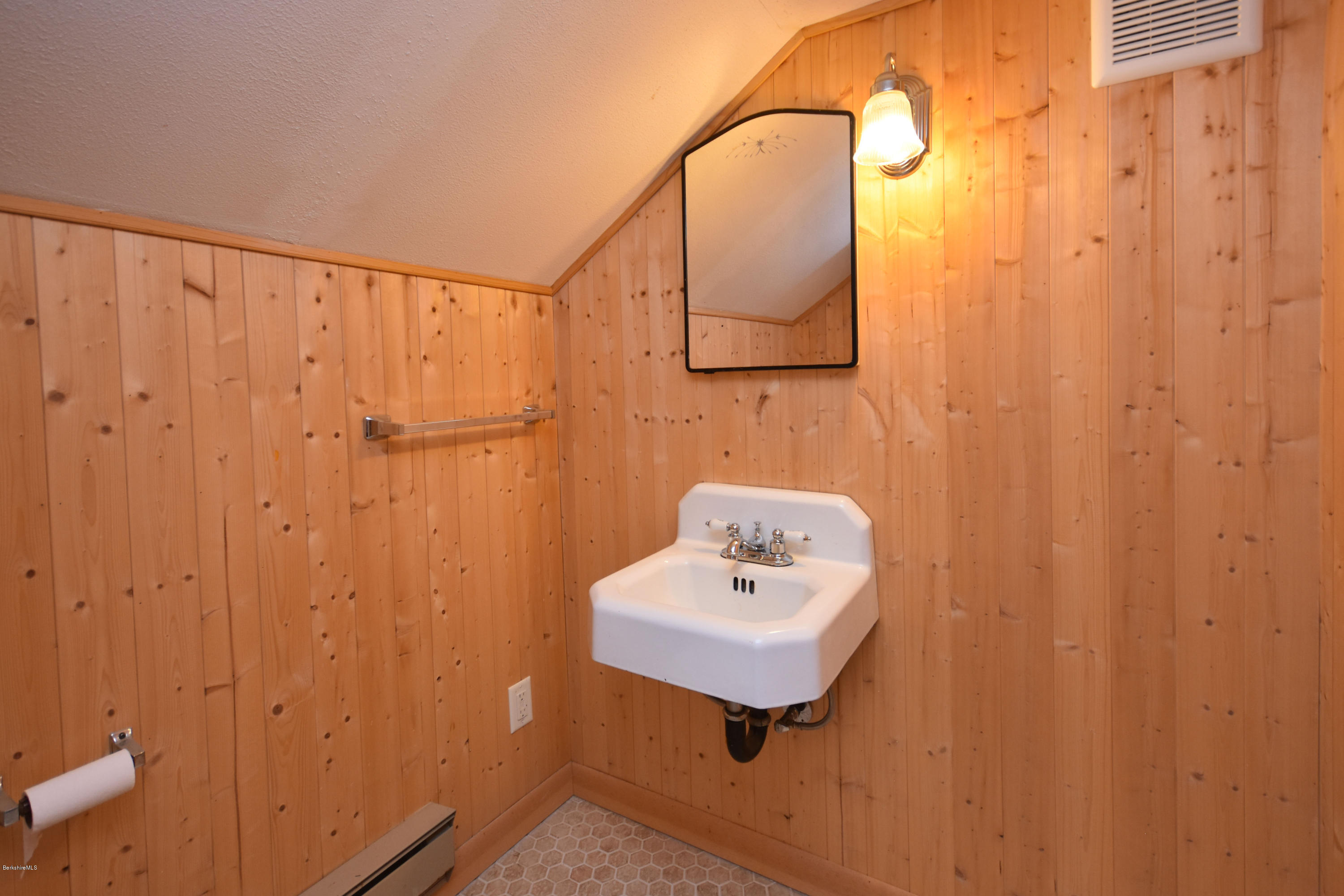 834 George Carter Road Becket, MA 01223 - Photo 44 of 61 a bathroom with a sink a mirror and shower curtain