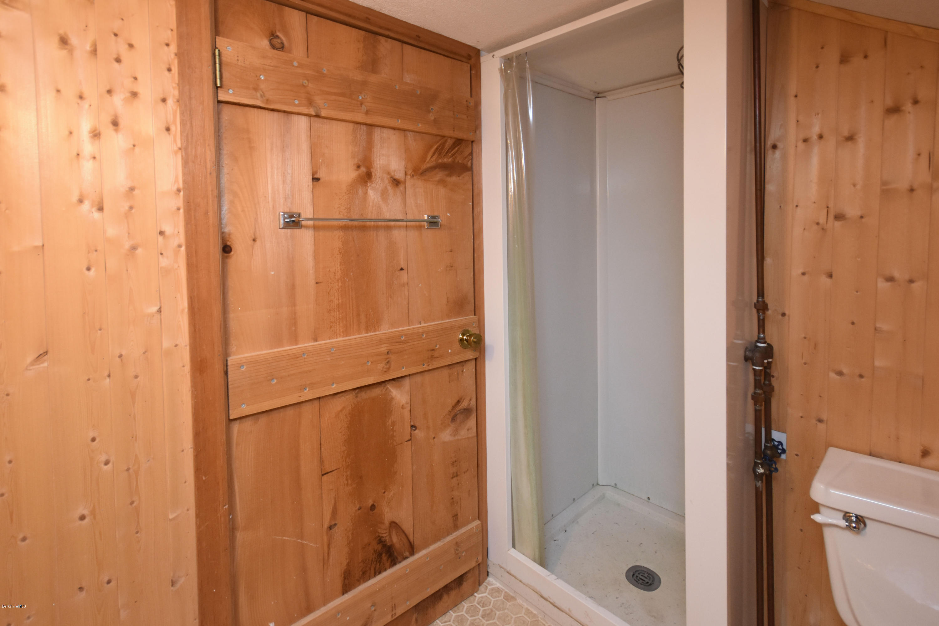 834 George Carter Road Becket, MA 01223 - Photo 45 of 61 a bathroom with a glass shower door