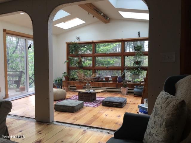 834 George Carter Road Becket, MA 01223 - Photo 6 of 61 a living room with furniture and a floor to ceiling window