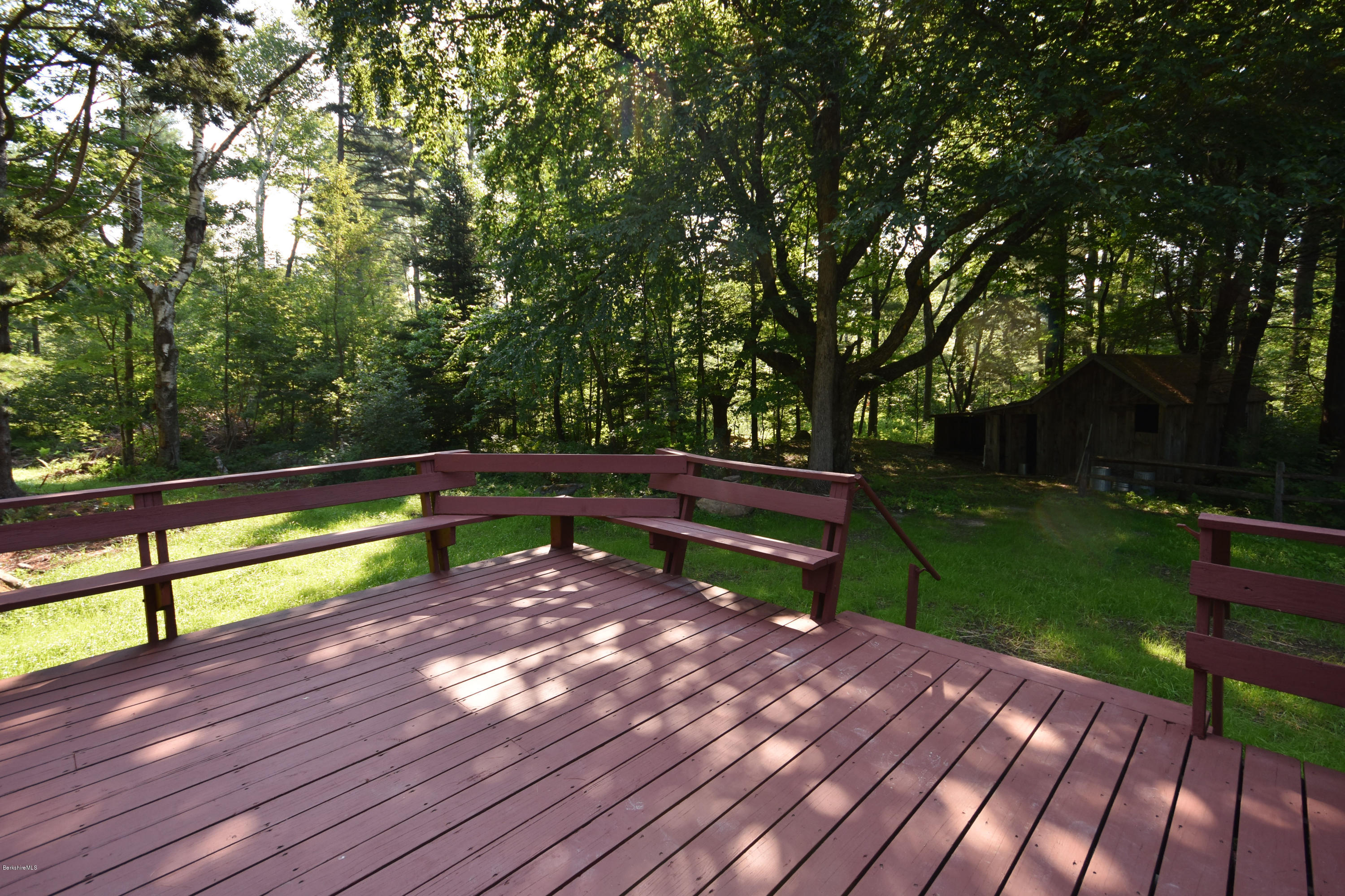 834 George Carter Road Becket, MA 01223 - Photo 54 of 61 a view of a bench in a yard