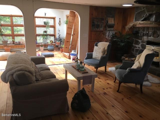 834 George Carter Road Becket, MA 01223 - Photo 8 of 61 a living room with furniture and a floor to ceiling window