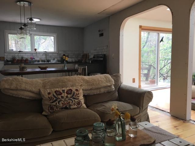 834 George Carter Road Becket, MA 01223 - Photo 9 of 61 a living room with furniture and a large window