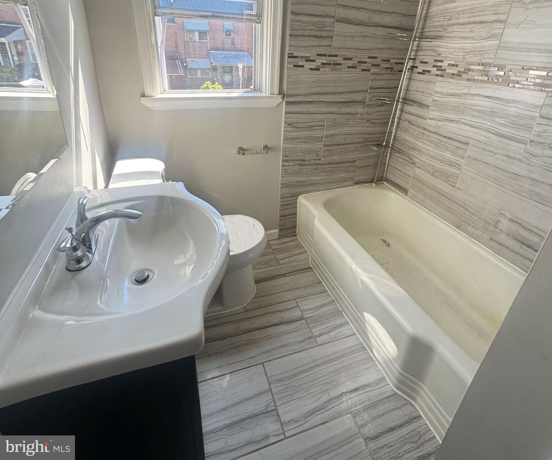 4014 Century Road Baltimore, MD 21206 - Photo 13 of 19 a bathroom with a sink and a bathtub