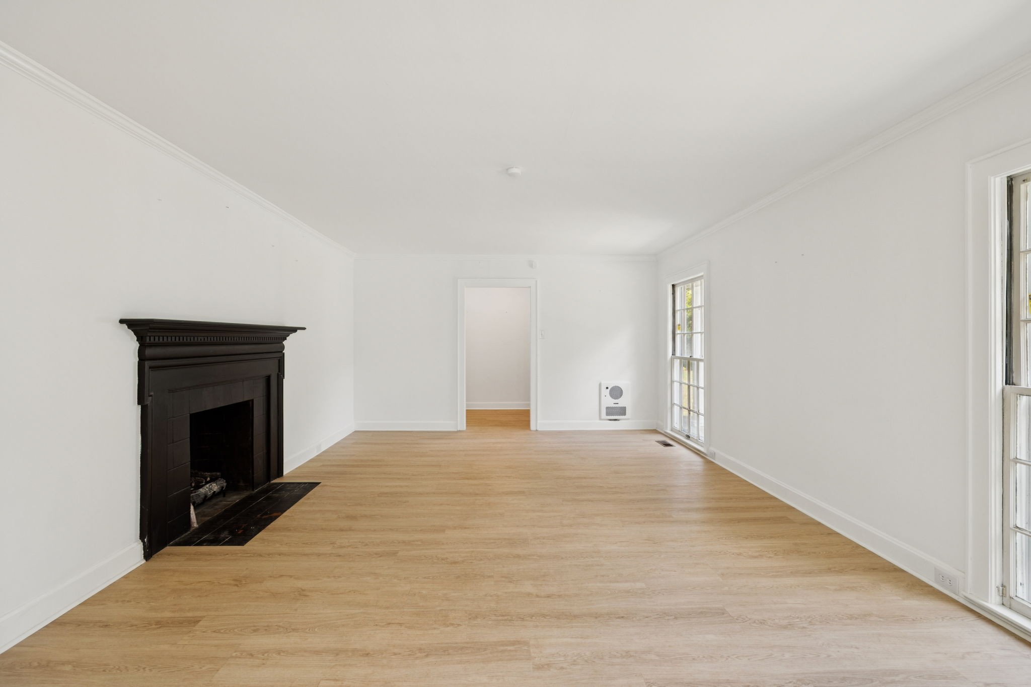 527 East Madison Street Pulaski, TN 38478 - Photo 20 of 74 a view of empty room with wooden floor and fireplace